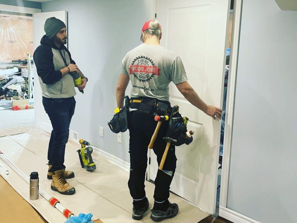 The finish carpenter who works at Wood Job Finish Carpentry is installing an interior door