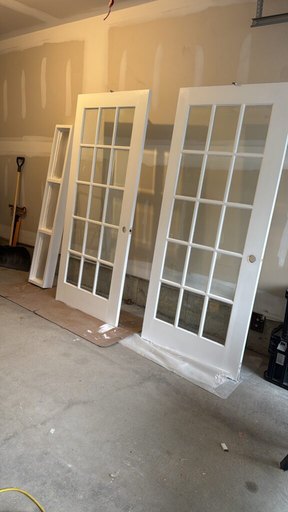 the finish carpenter working on a custom French door and transom in Oakville
